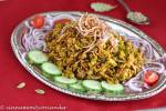 Mujaddara Arabic Lentil and Rice Pilaf served with some sliced cucumbers and fried onions