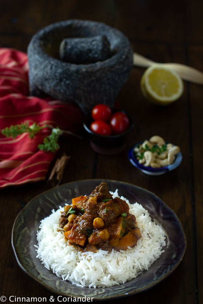 overhead shot of Venison Curry Vindaloo (Indian Venison Stew) with chickpeas and squash served on a bed of rice