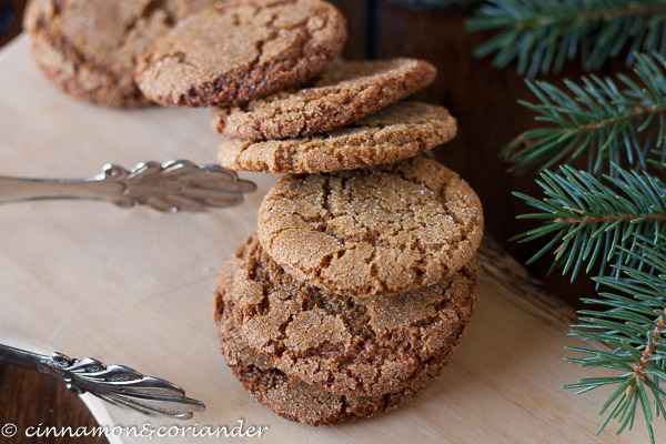 a stack of crispy and chewy bacon fat gingersnap cookies on a wooden board