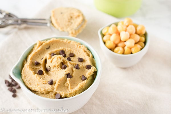 a small bowl of healthy vegan cookie dough with chickpeas and chocolate chips on the side