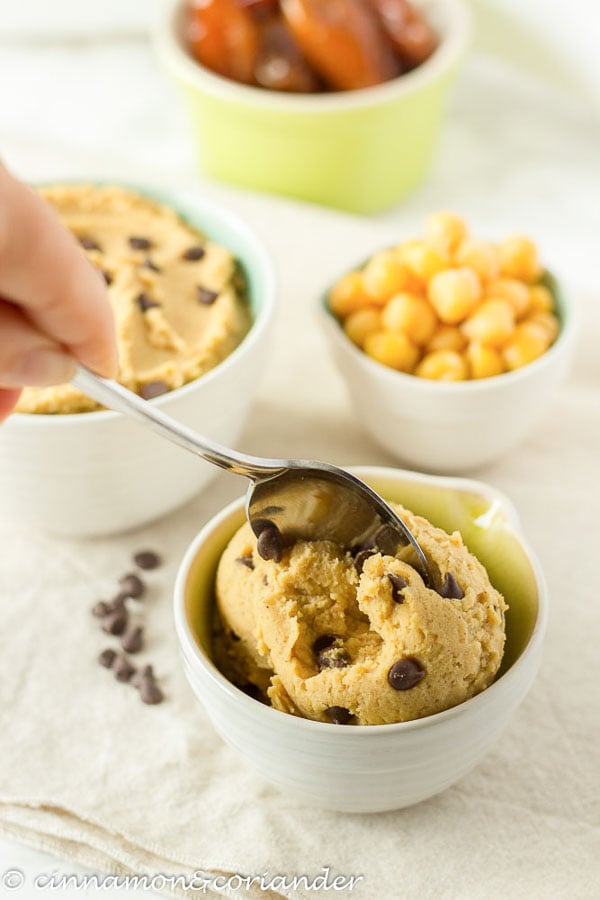 a big scoop of vegan cookie dough made from chickpeas in a small bowl