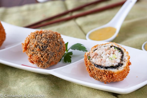 Crispy Fried Japanese Tuna Rice Balls served on an appetizer platter with orange sauce on the side