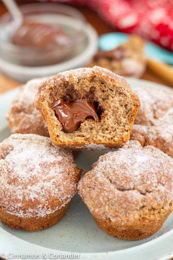 Nutella Stuffed Gingerbread Snickerdoodle Muffins with whole wheat flour on a blue plate