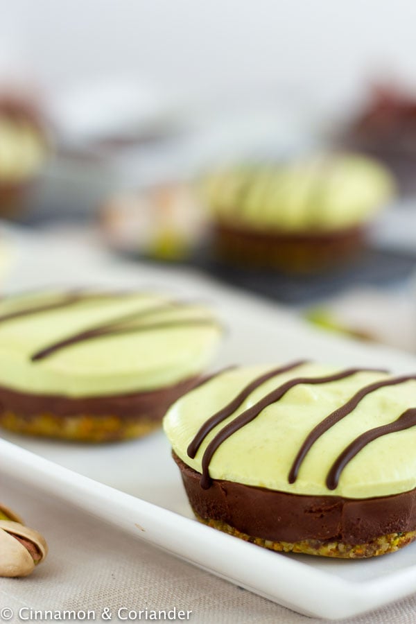 Vegan Raw No-Bake Nutella Pistachio Mini Cheesecake on a white plate - side view