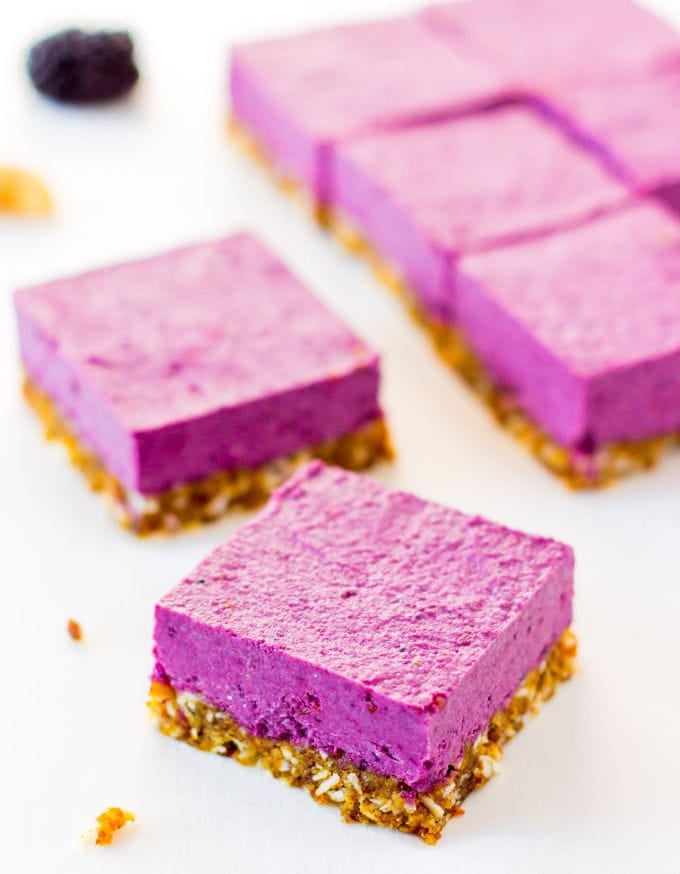 Raw Vegan Blackberry Cheesecake Squares on a white tabletop