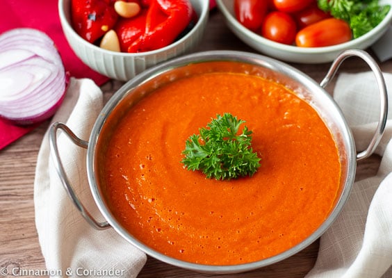 vegan roasted red pepper sauce in a silver sauce dish