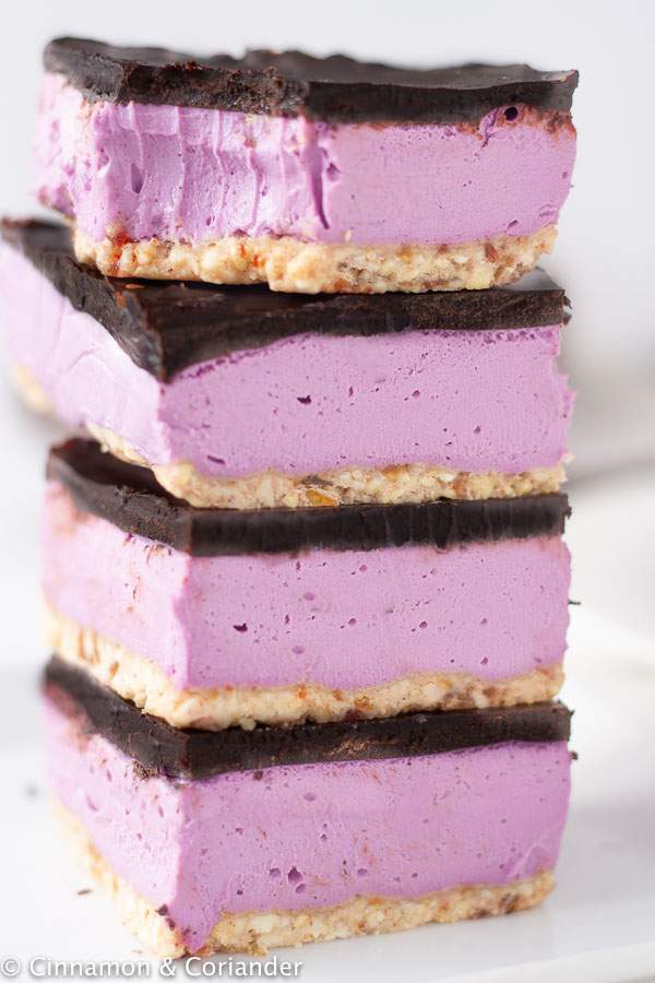 close-up of Vegan Nanaimo Bars with purple sweet potato and coconut cream