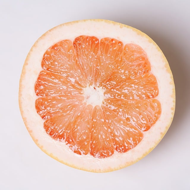 a slice of grapefruit on a white surface