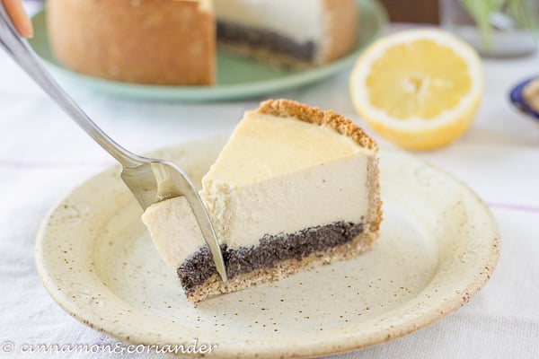 a fork sliding into a piece of healthy vegan tofu cheesecake with sugar-free poppy seed filling