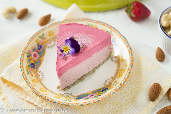a slice of healthy strawberry raw vegan cheesecake on a plate