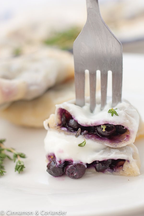 blueberry pierogi covered with sour cream