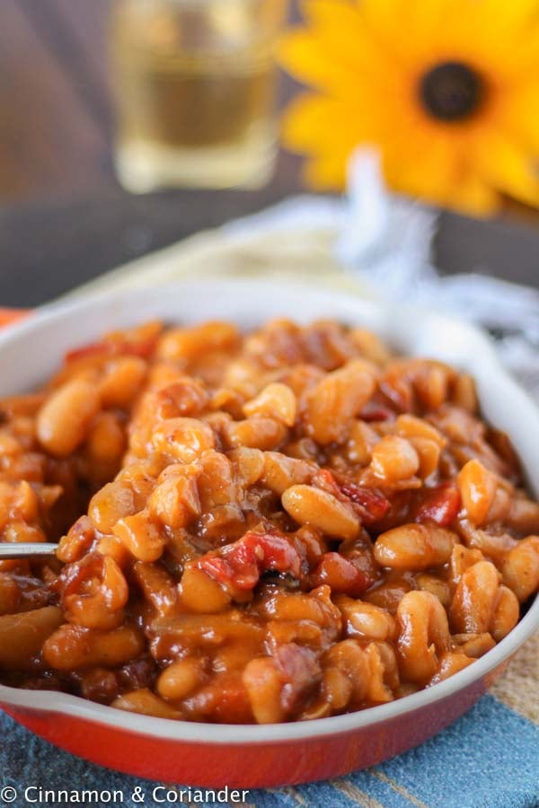 Maple Molasses Baked Beans with Bacon in a small white skillet