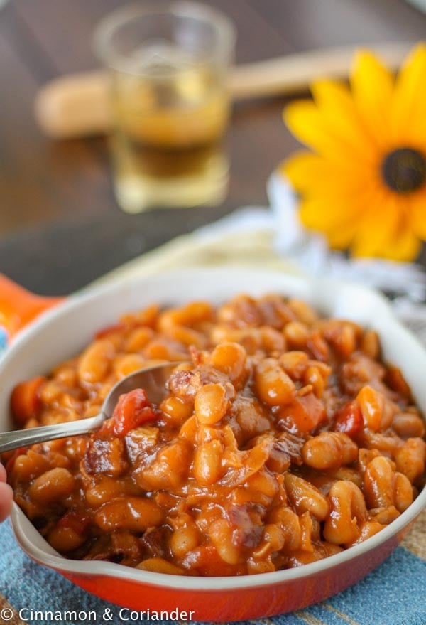 close-up of a skillet with maple molasses baked beans with bacon