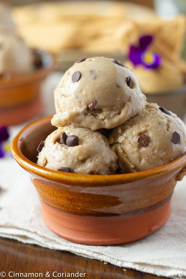 three scoops of healthy vegan peanut butter cookie dough in a small dessert bowl