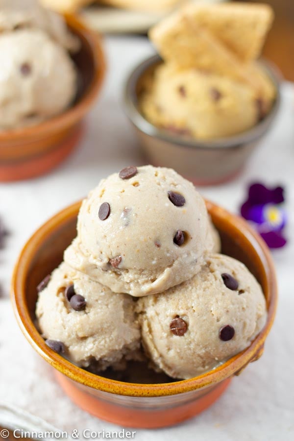 three scoops of healthy vegan peanut butter cookie dough ice cream with chocolate chips in a bowl
