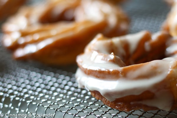 side view of a freshly glazed Apple Cider French Cruller with Maple Icing 