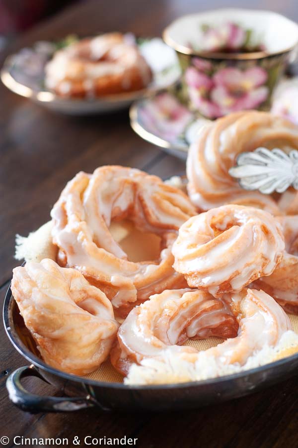 Apple Cider Donuts aka. French Crullers with Maple Icing on a rustic silver platter