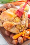 Maple Whole Roast Chicken with Stuffing on a bed of oven-roasted vegetables