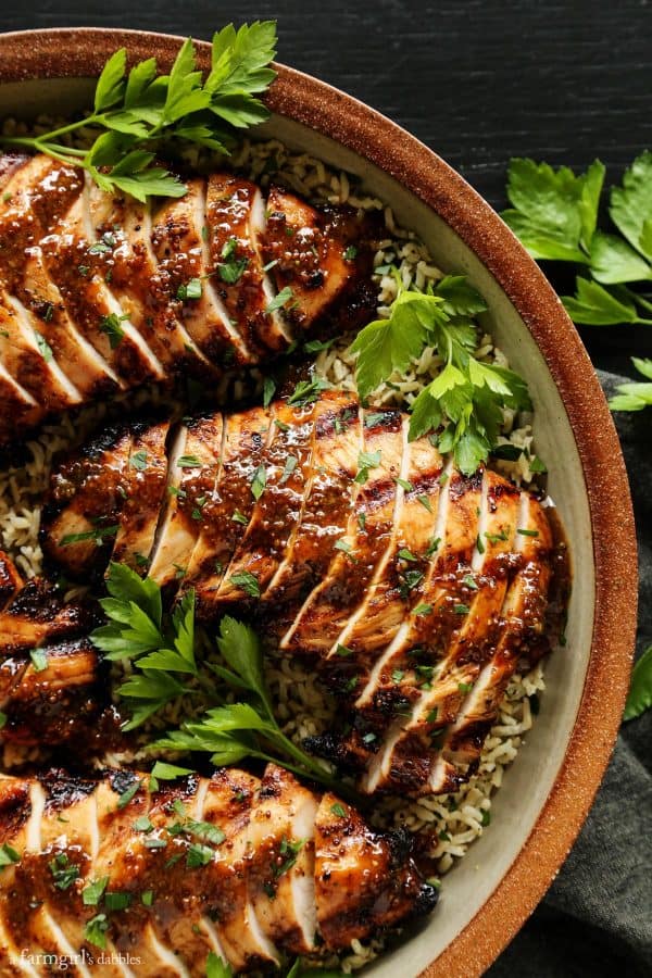 overhead shot of grilled and sliced brown sugar turkey tenderloins served on a bed of rice