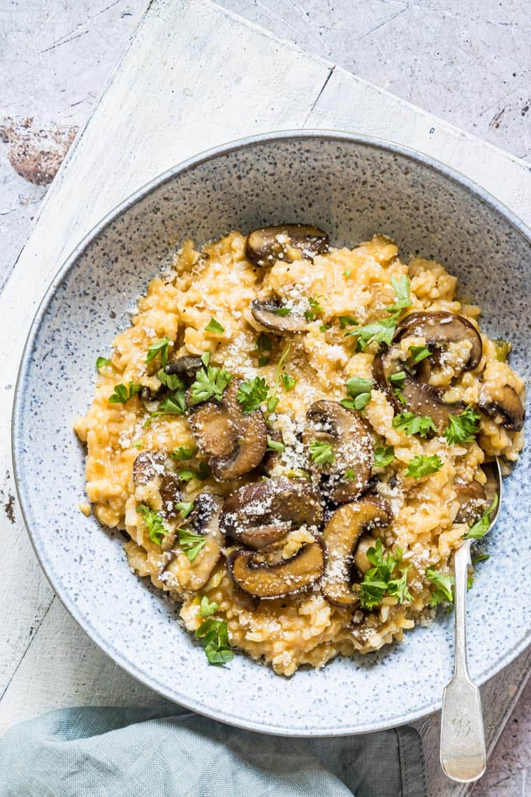 overhead shot of a plate of Instant Pot Mushroom Risotto with pumpkin topped with parmesan