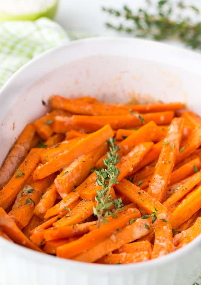roasted carrots in a white casserole dish
