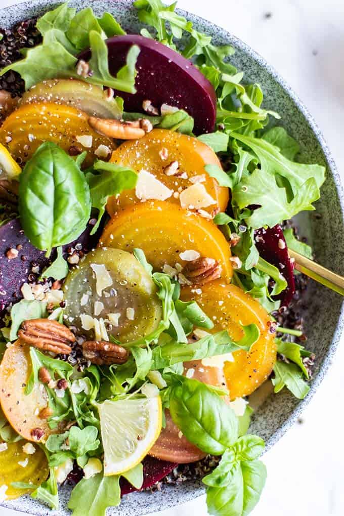 overhead shot of a cold beet salad in a rustic salad bowl