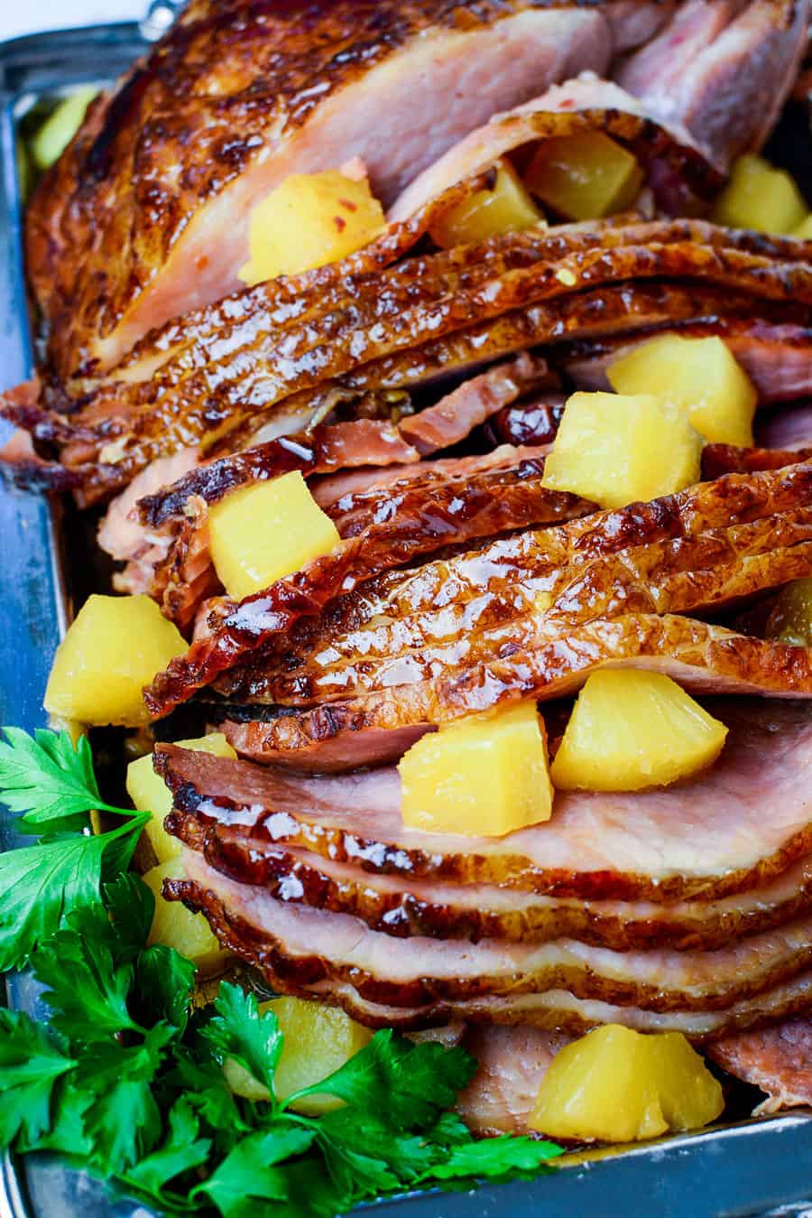 overhead shot of a slow cooker glazed ham with pineapple chunks