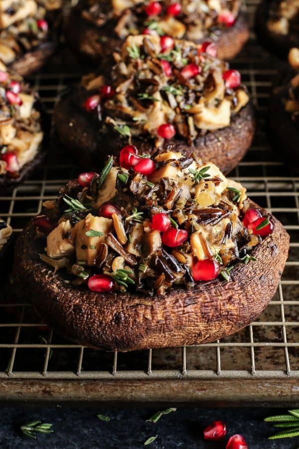 side view of stuffed portobello mushrooms stuffed with wild rice and pomegranate seeds