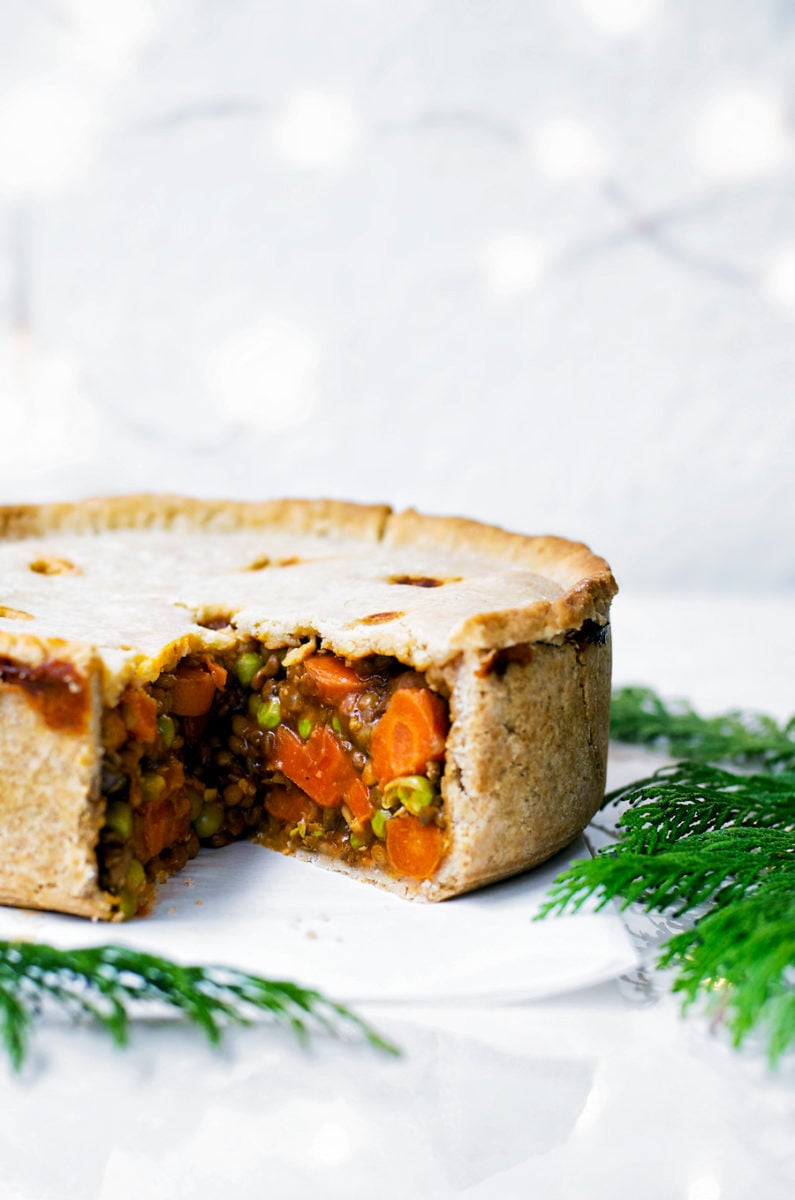 side view of a veggie filled vegan Thanksgiving pie made with hot water crust pastry