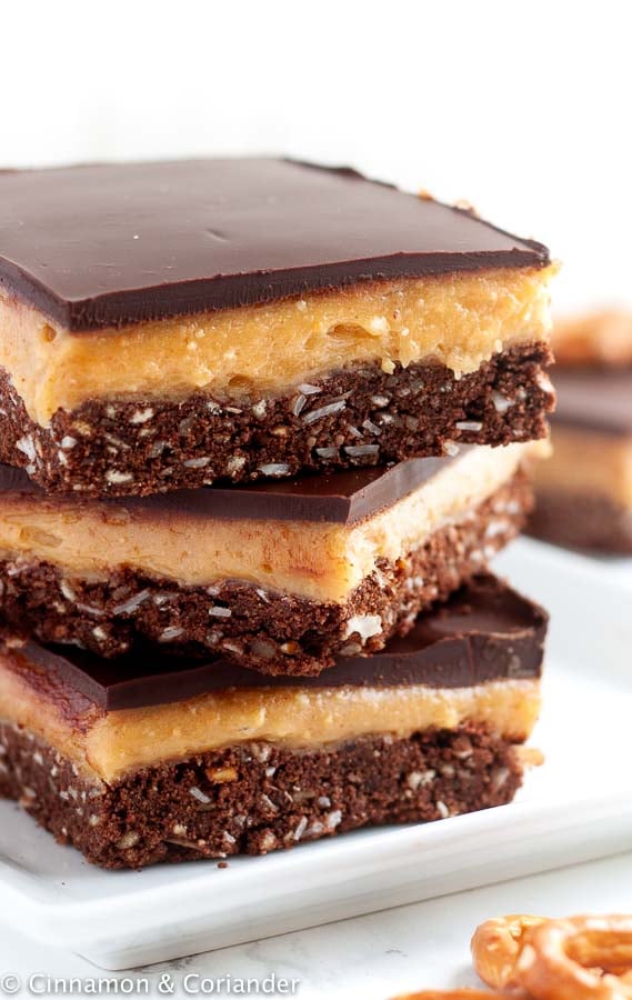 side view of a stack of Peanut Butter Nanaimo Bars with Pretzel Crust
