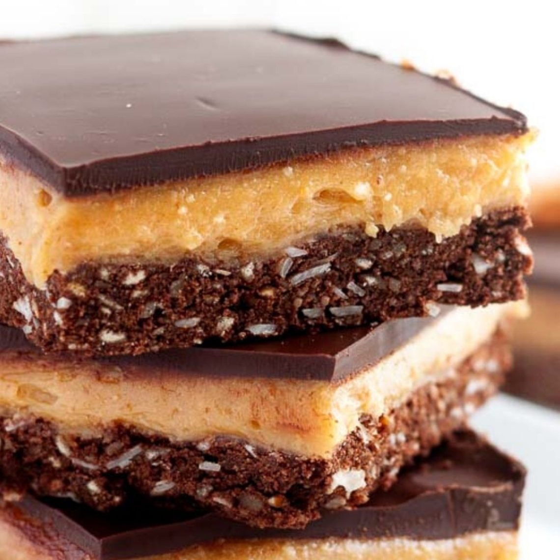 Side view of Peanut Butter Nanaimo Bars with Pretzel Crust
