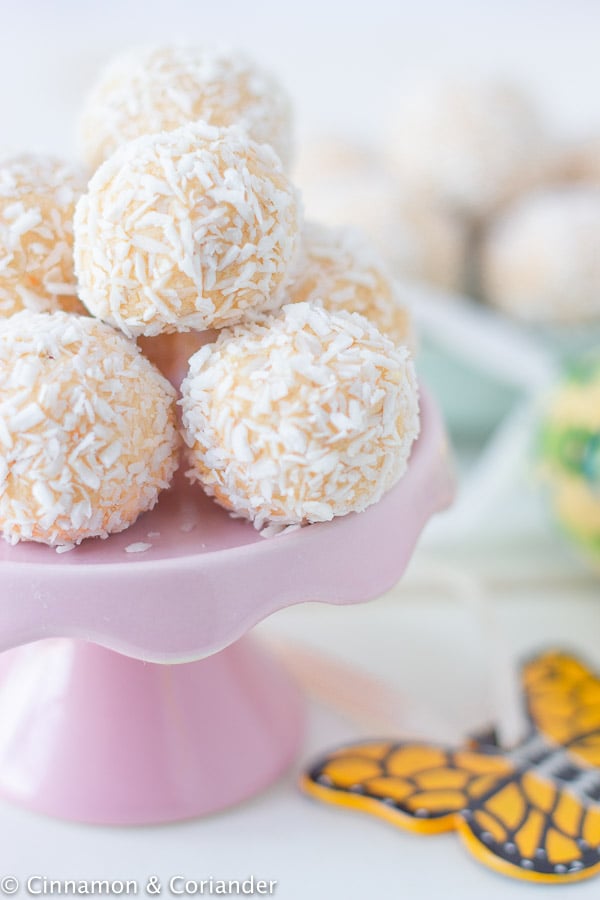 homemade passionfruit cheesecake bites on a small pink cake stand 