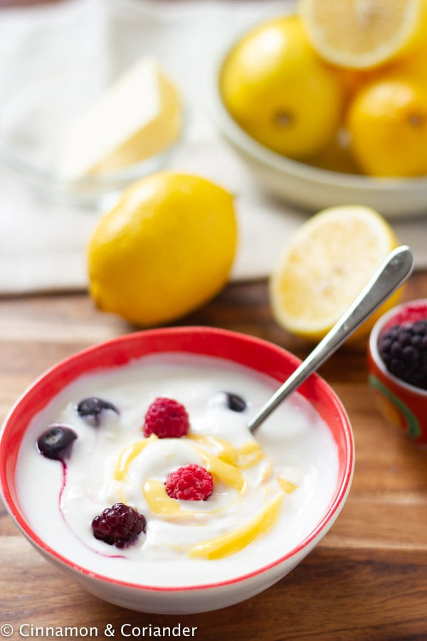 a bowl with Greek yogurt with some sugar-free lemon curd and berries swirled in 