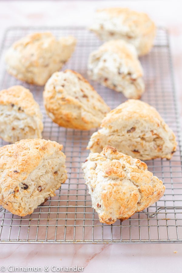 fluffy vegan scones with dates and almonds on a wire cooling rack 