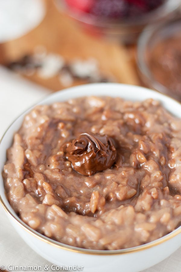 close-up of a bowl of creamy Instant Pot chocolate rice pudding topped with a big dollop of Nutella