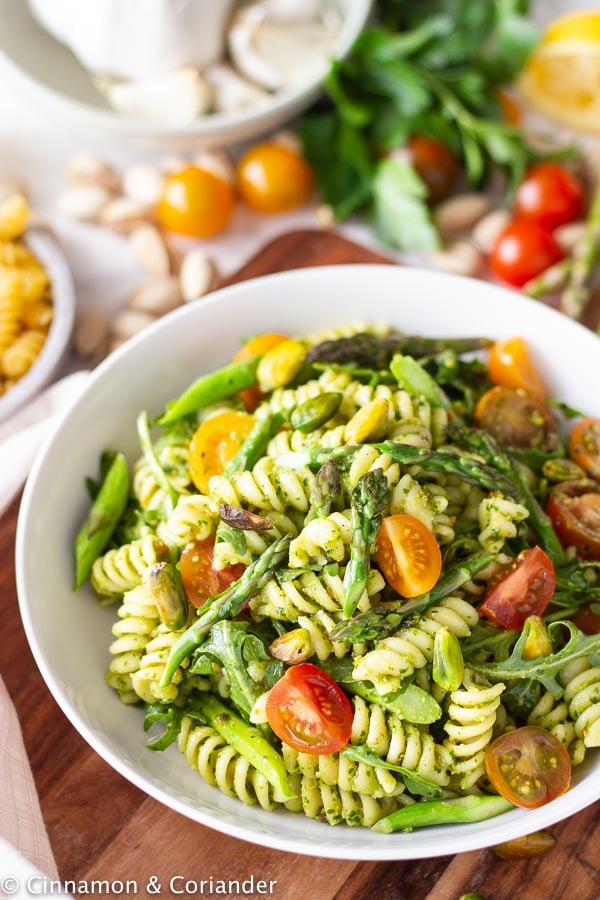 side view of a big platter with pistachio pesto pasta salad 