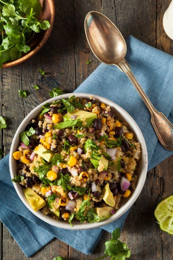 overhead shot of a bowl of Mexican Quinoa Salad with charred corn, avocado and cilantro lime dressing 