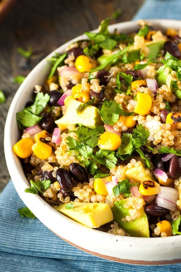 a bowl with warm Mexican Quinoa Salad with charred corn, black beans and cilantro lime dressing 