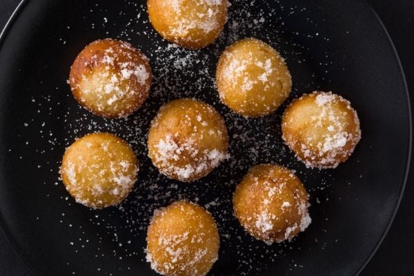 overhead shot of Beltane Honey Fritters on a black plate