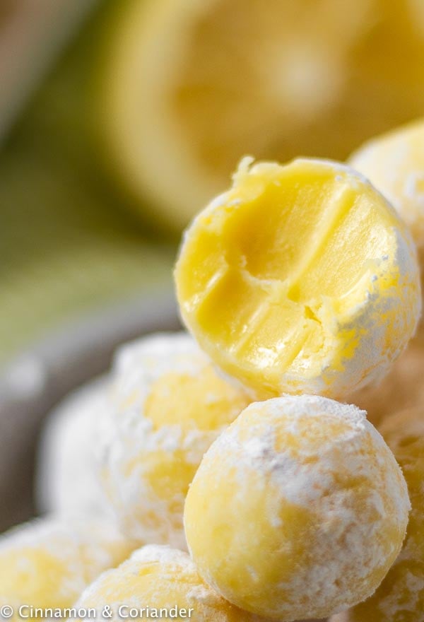 close up of a no bake lemon white chocolate truffle with one bite taken