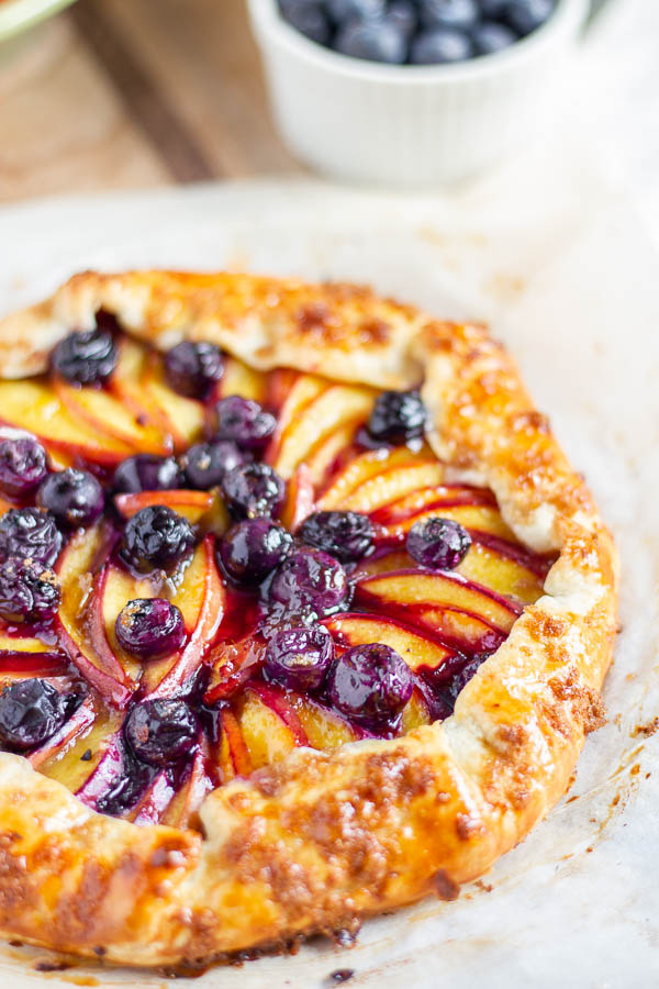 side view of a rustic nectarine blueberry galette 