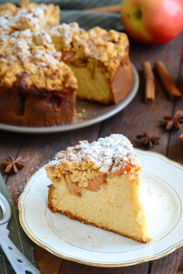 a slice of old fashioned German Apple Cake with Streusel Topping on a porcelaine plate