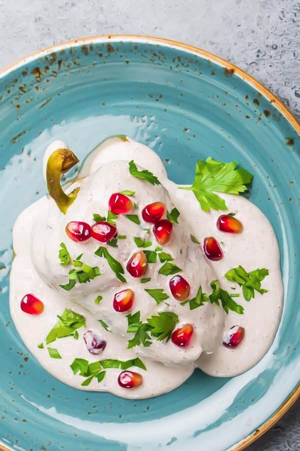 vegan chile en nogada served with walnut sauce and pomegranate seeds