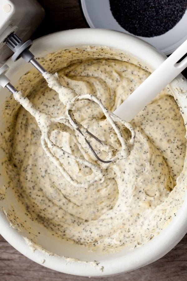 marzipan muffins batter with poppy seeds being mixed