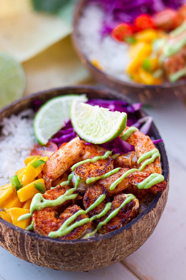Mexican Shrimp Taco Bowl with mango salsa, rice, lime wedges and homemade cilantro lime mayo