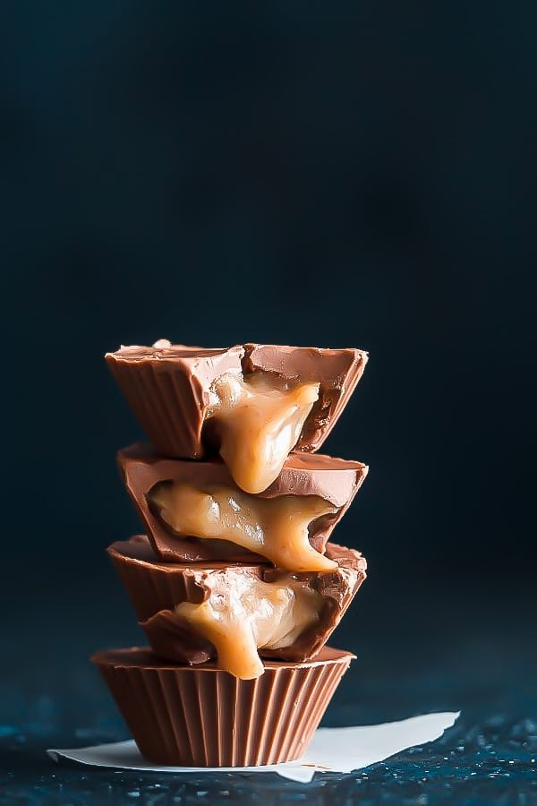 stacked vegan chocolate cups filled with salted tahini caramel sauce