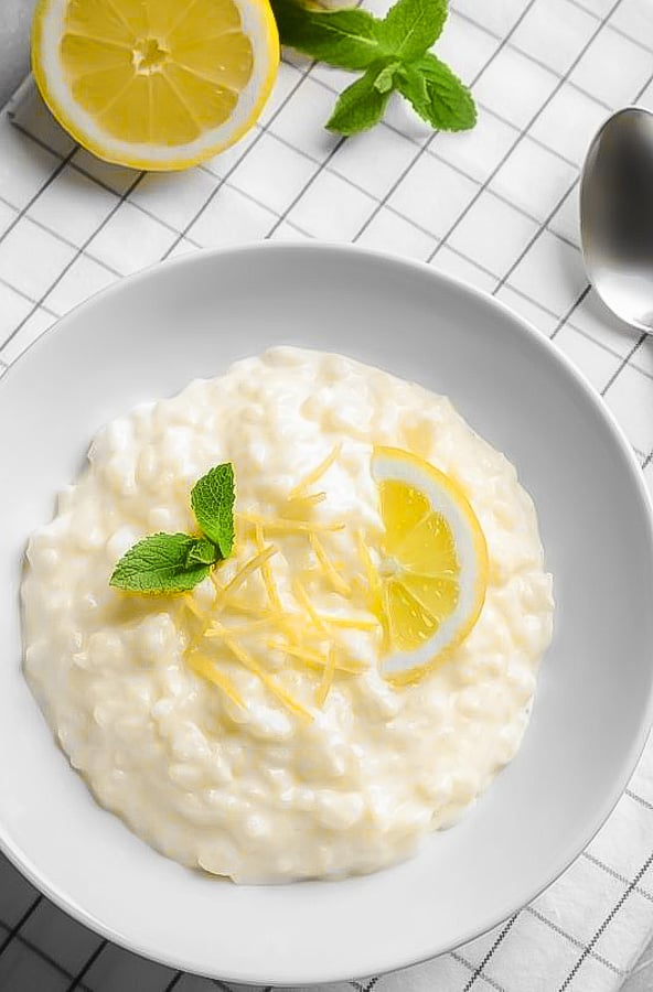 overhead shot of creamy lemon rice pudding garnished with mint and lemon zest