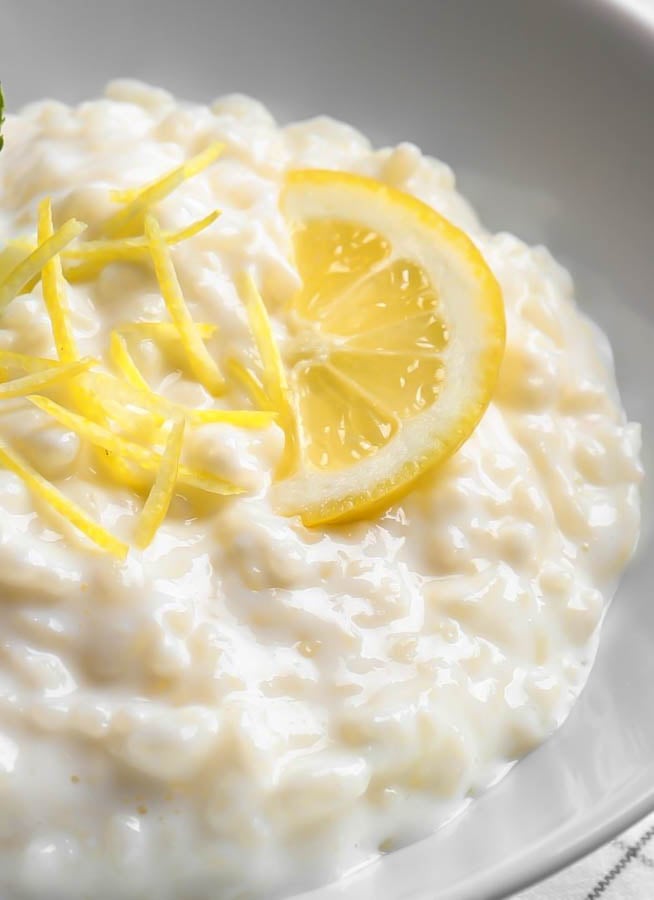 close-up of creamy lemon rice pudding topped with lemon zest