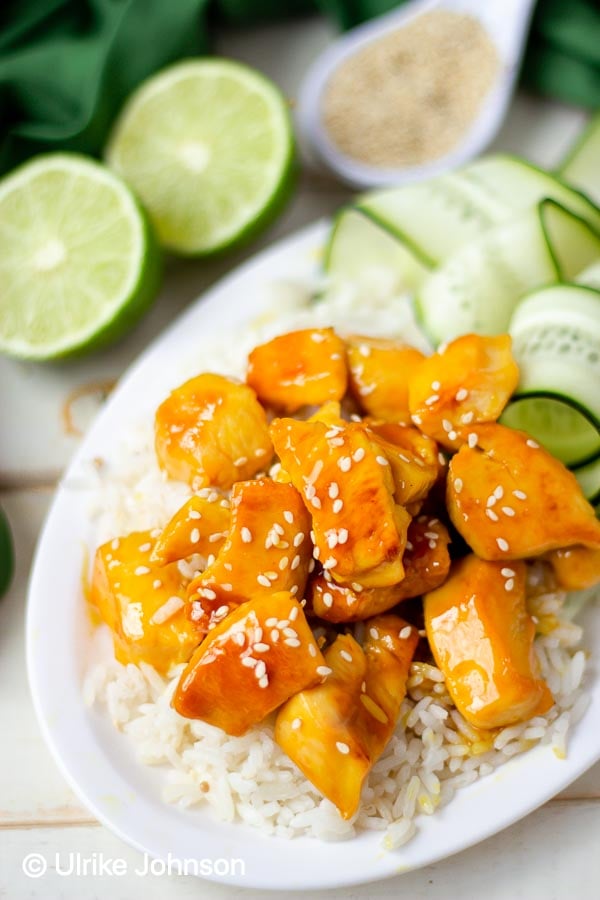 Healthy Easy Panda Express Copycat Chinese Orange Chicken served over rice sprinkled with sesame seeds