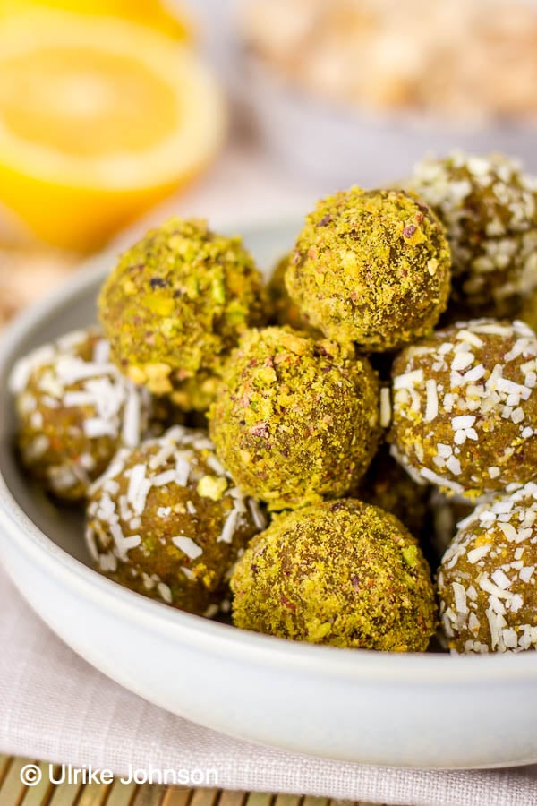 no bake vegan pistachio lemon date energy balls with in a small bowl